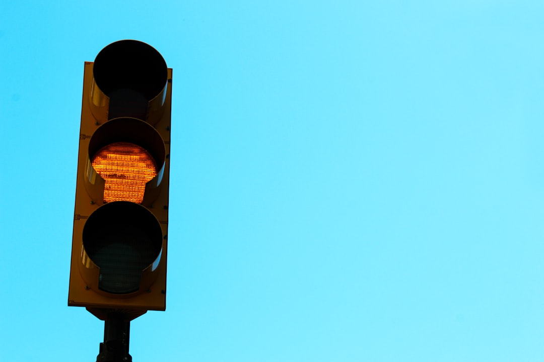 a traffic light with a blue sky in the background,
