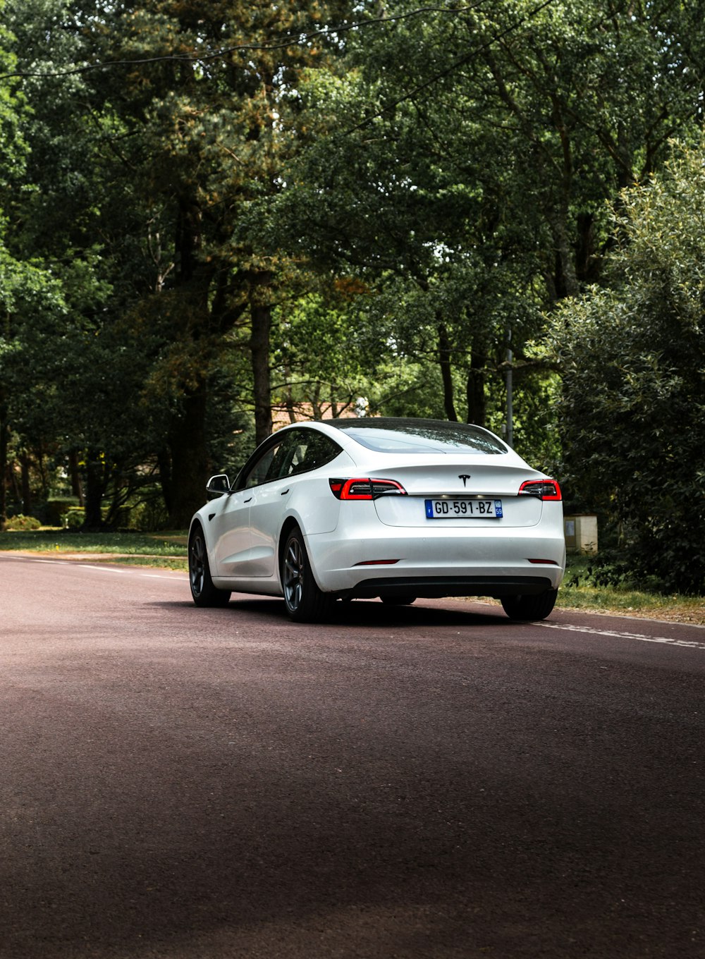 a white car parked on the side of a road