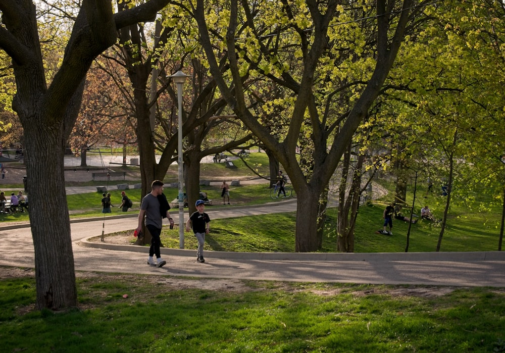 a group of people walking through a park