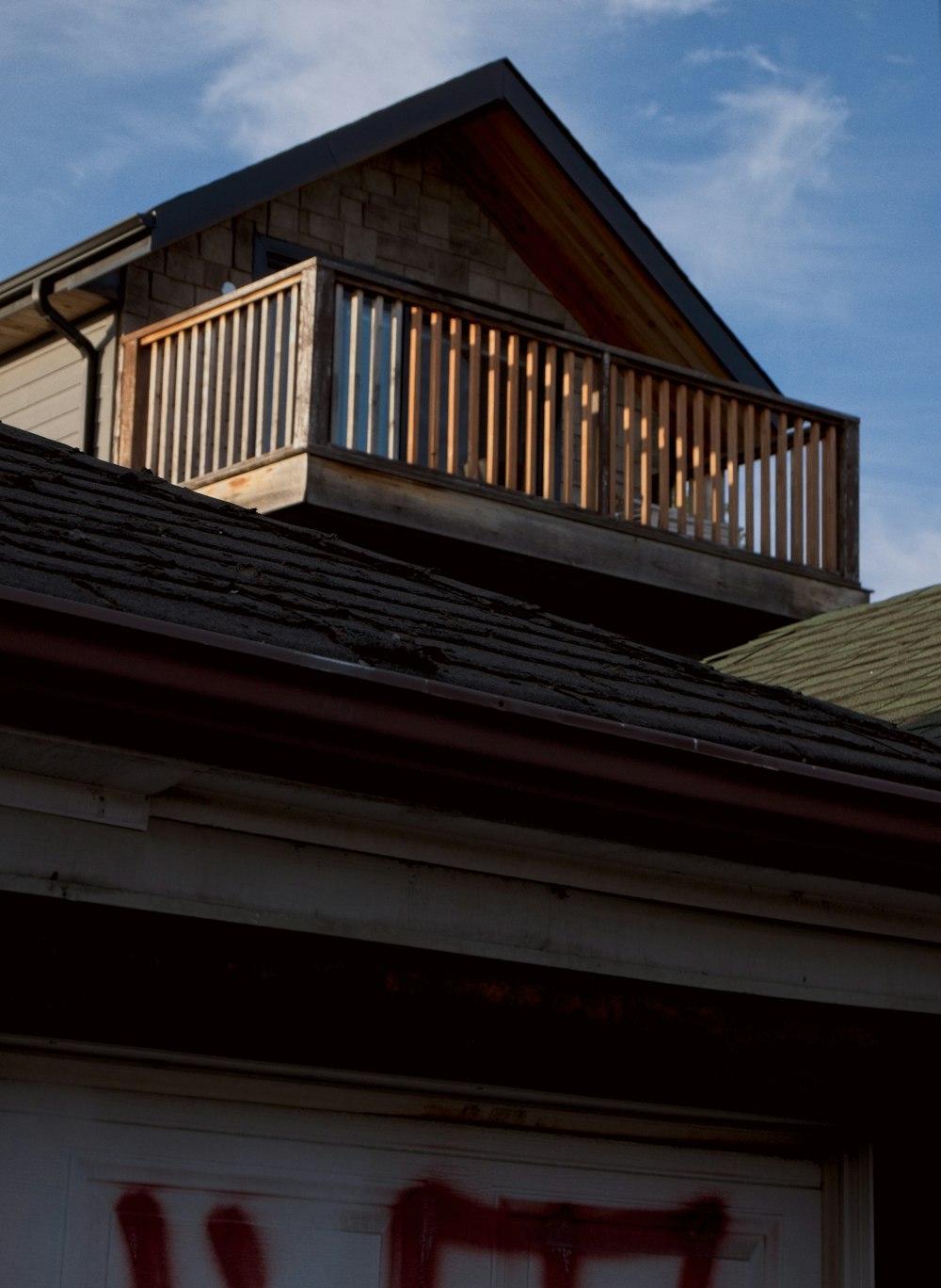 a picture of a house with graffiti on the roof