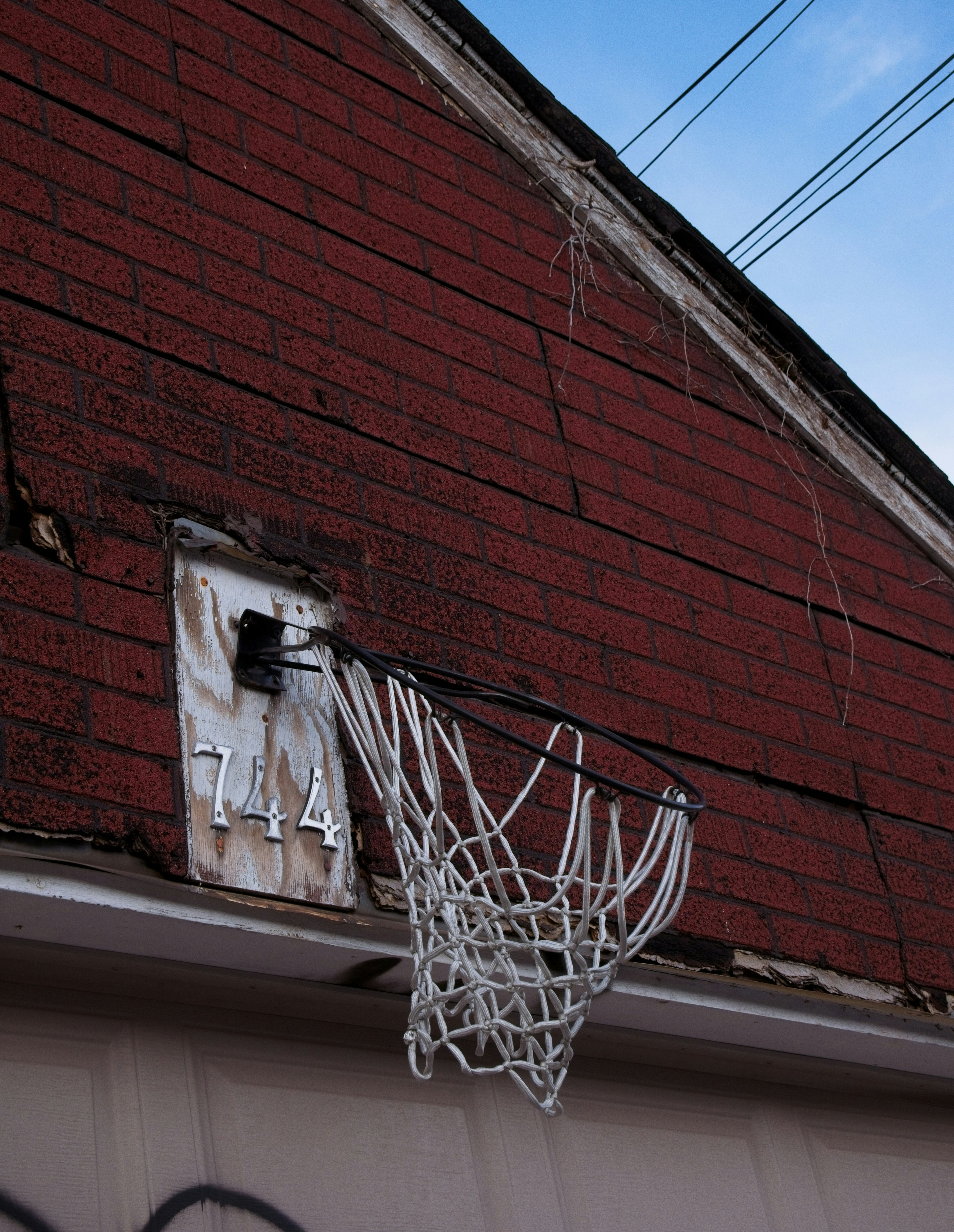a basketball hoop hanging from the side of a building
