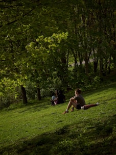 A mentor encouraging a new believer during an outdoor conversation in a peaceful park.