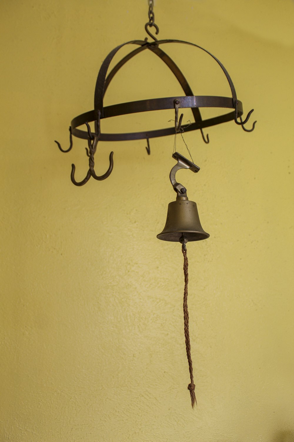 a bell hanging from the side of a wall