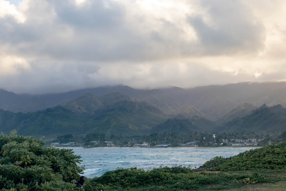 a view of a body of water with mountains in the background