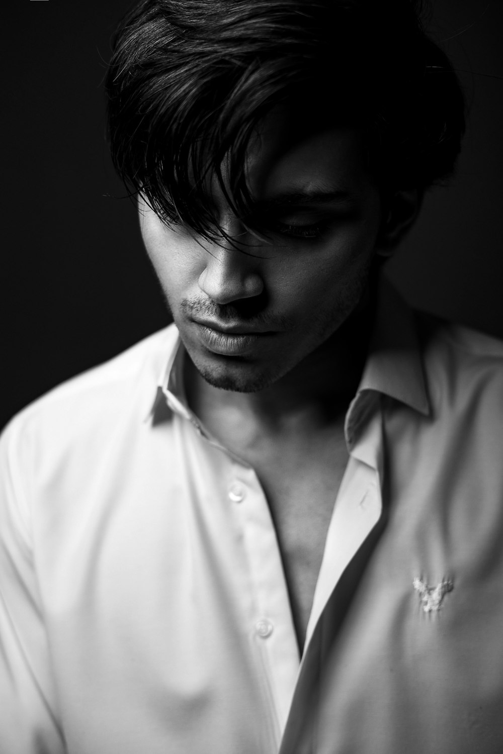 a black and white photo of a man in a shirt