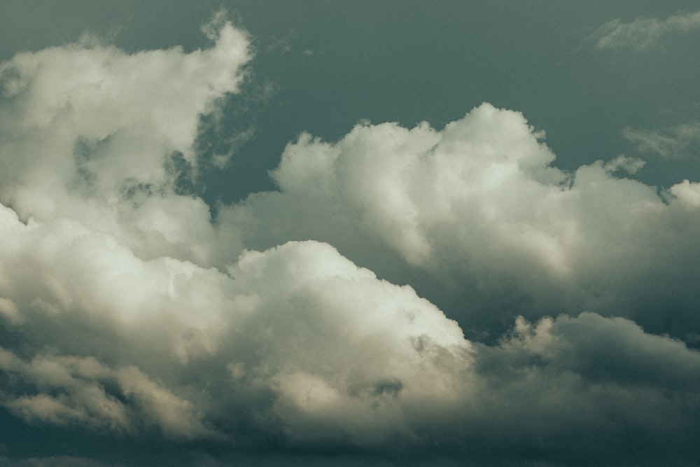 a plane is flying in the cloudy sky