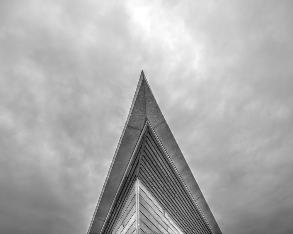 a black and white photo of a triangular building