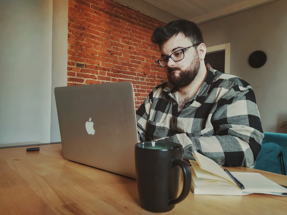 a man sitting in front of a laptop computer