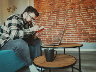 A student writing a statement of purpose on a laptop in a cozy study space.