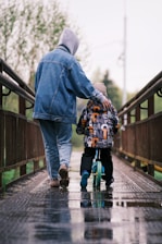 a man walking with a child on a bridge