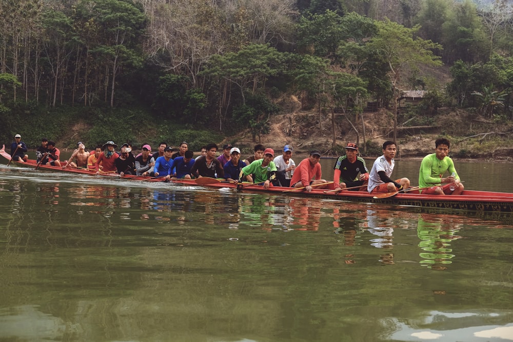 a group of people on a long boat in the water