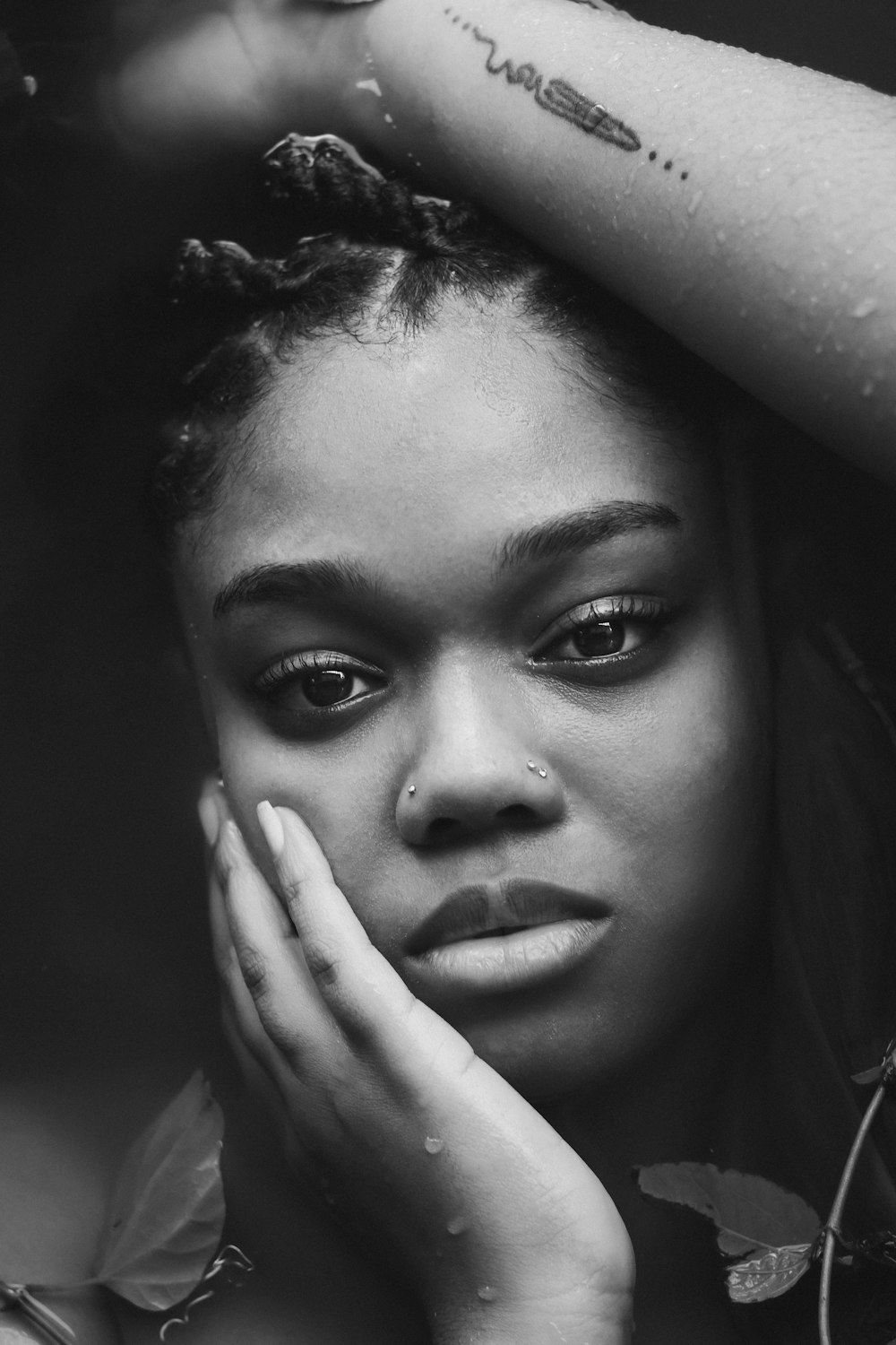 a black and white photo of a woman with her hands on her head