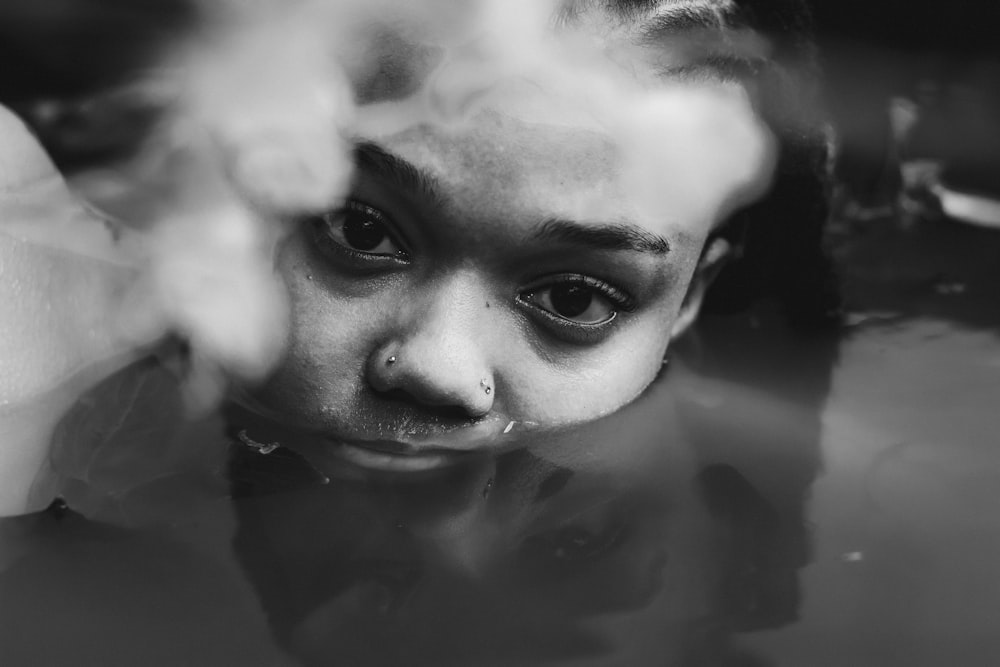a young girl in a pool of water with steam coming out of her face