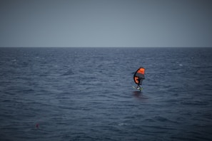 a person on a surfboard in the middle of the ocean