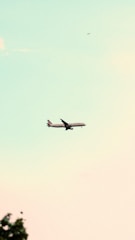 a large jetliner flying through a blue sky