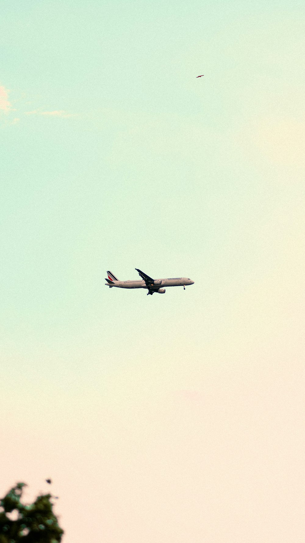 a large jetliner flying through a blue sky