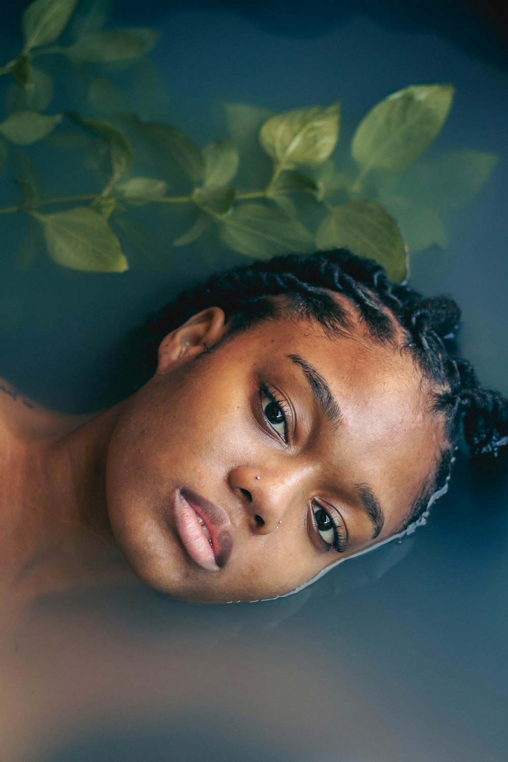 a young girl is floating in a pool of water