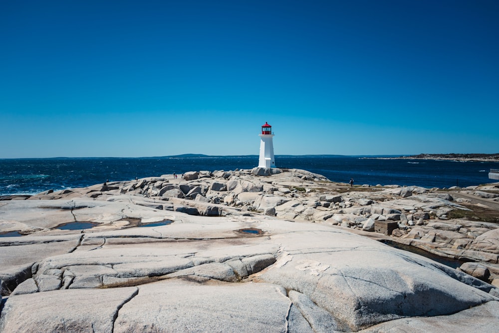 a light house sitting on top of a rocky shore