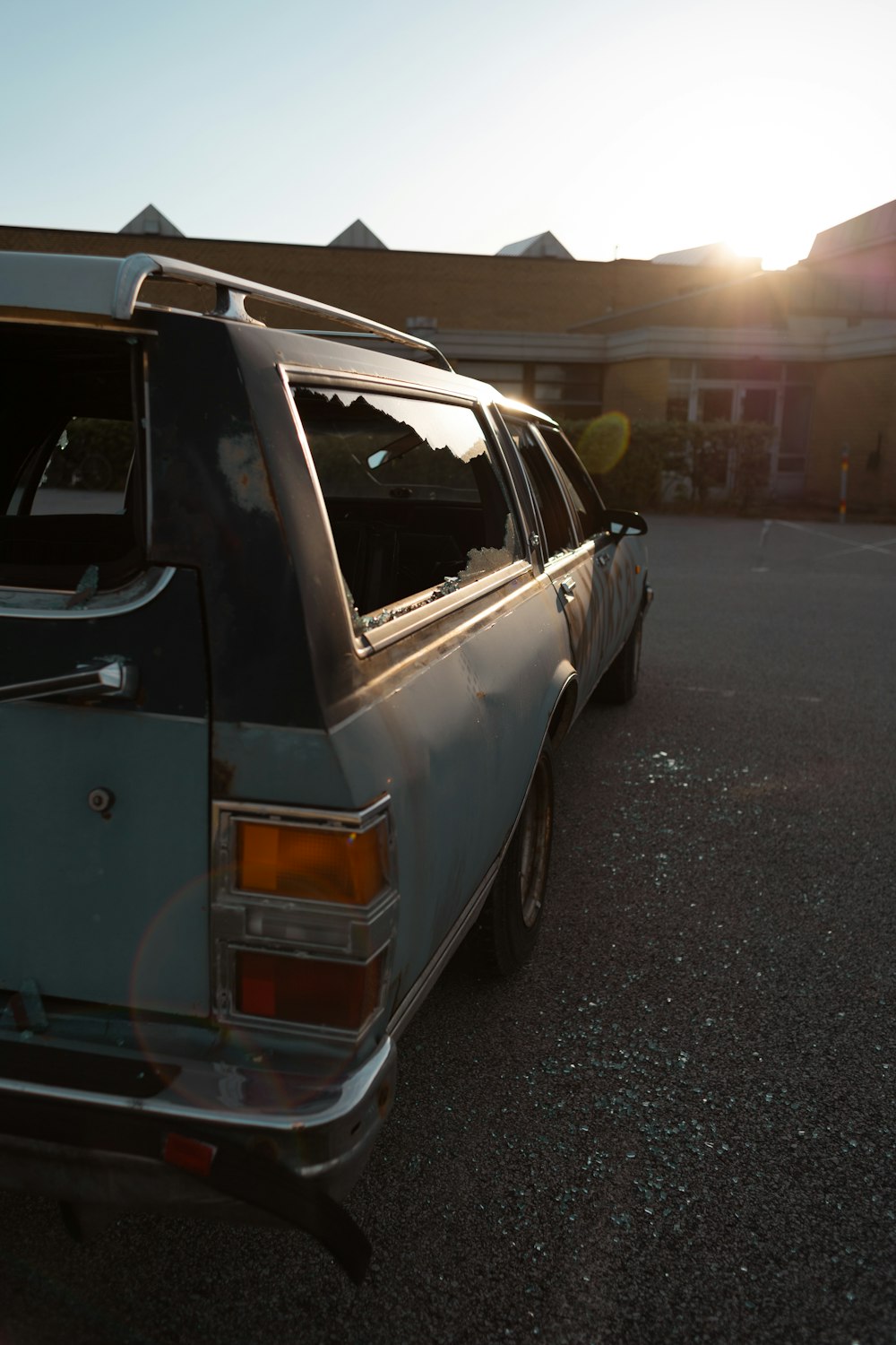 a white car parked in a parking lot next to a building