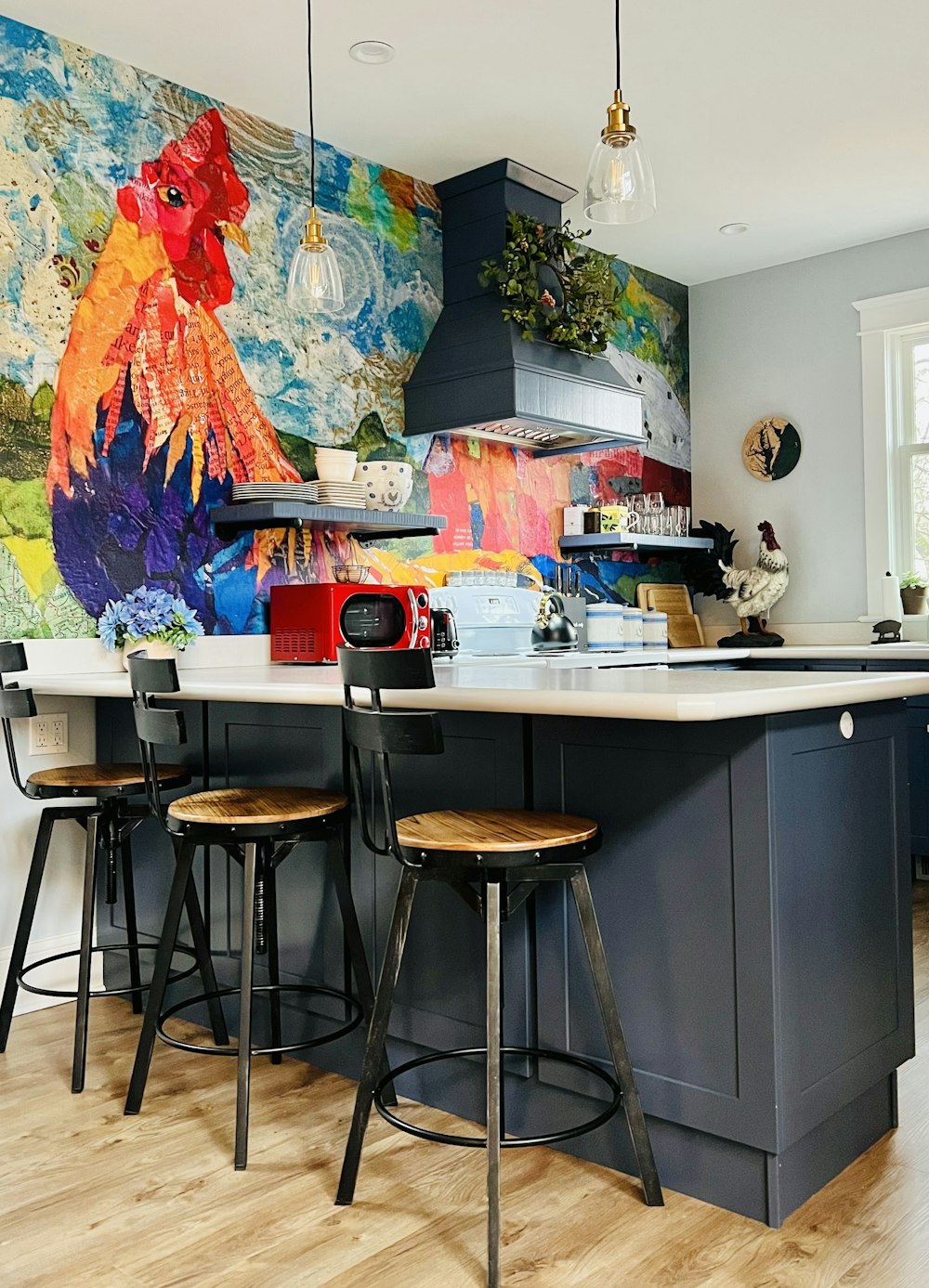 a kitchen with a large painting on the wall