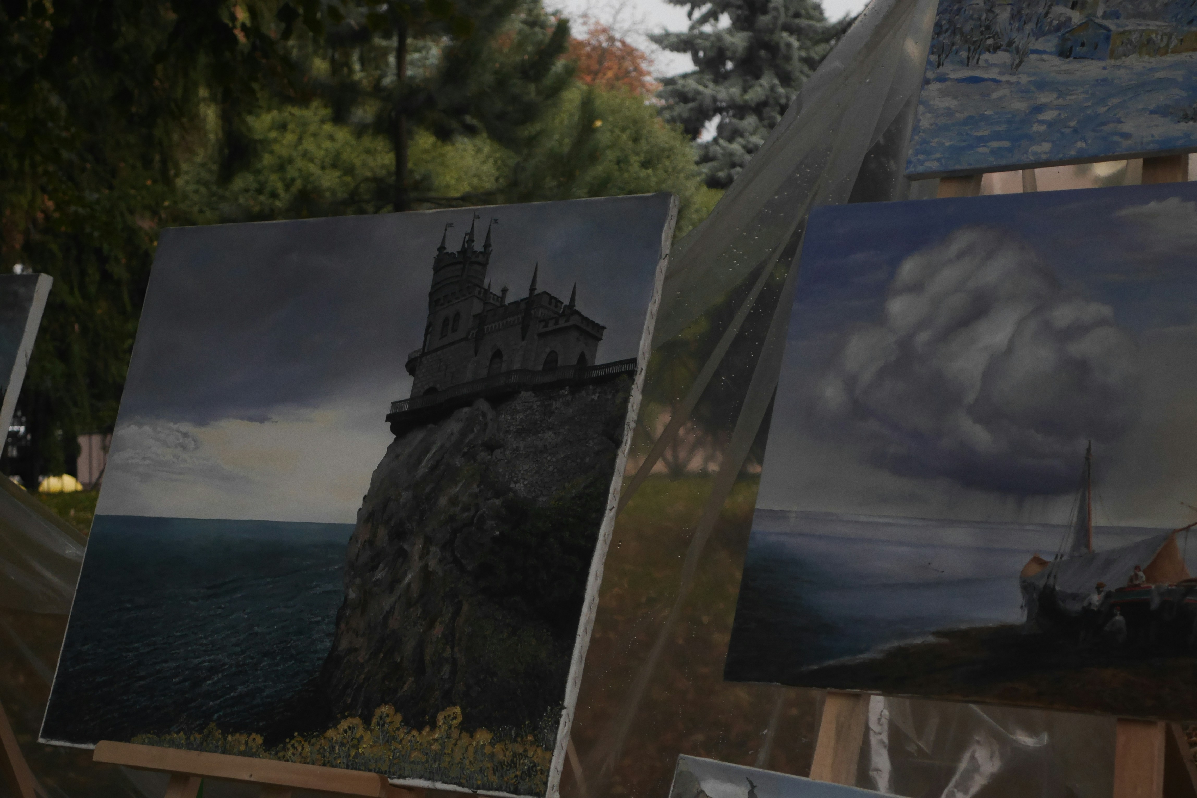 a painting of a castle on a cliff next to a body of water