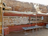 Colorful handmade souvenirs displayed neatly on a traditional market stall.