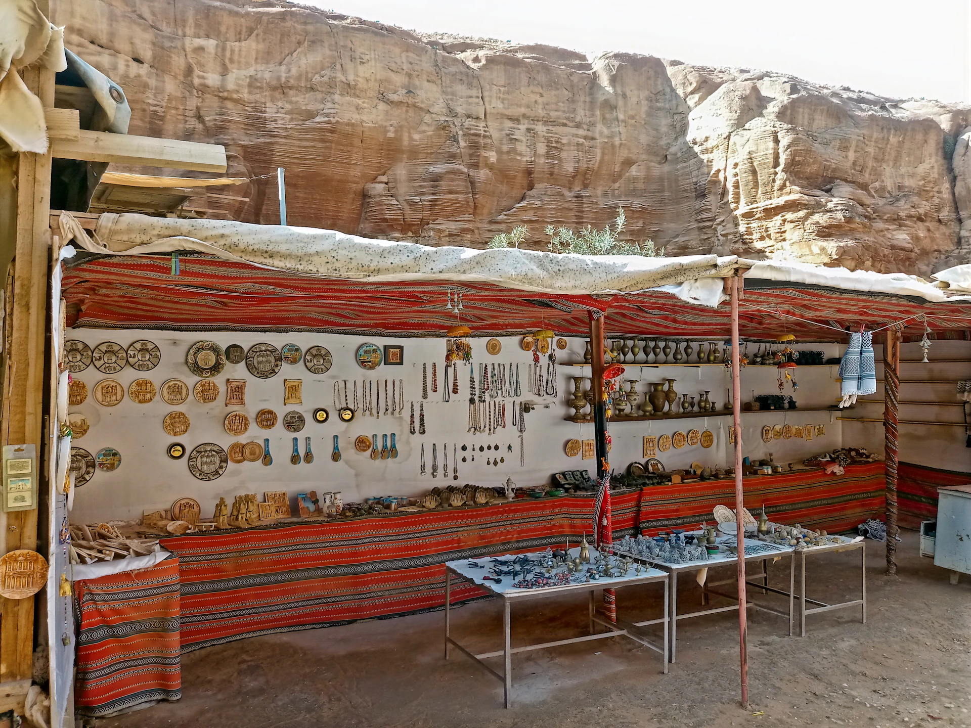 Close-up of a traditional Zacatecan craft market stall filled with handmade textiles and pottery.