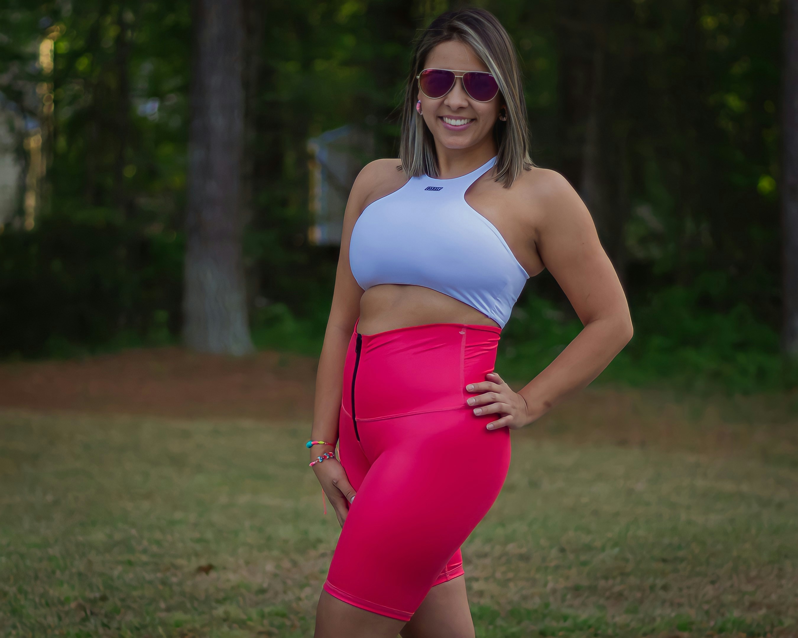 a woman in a pink and blue outfit posing for a picture