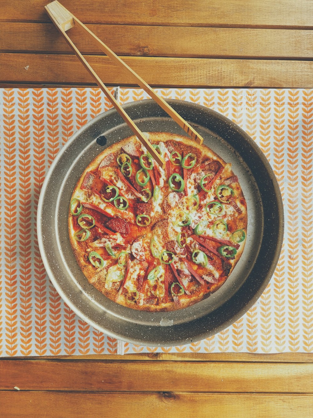 a pizza sitting on top of a pan on top of a table