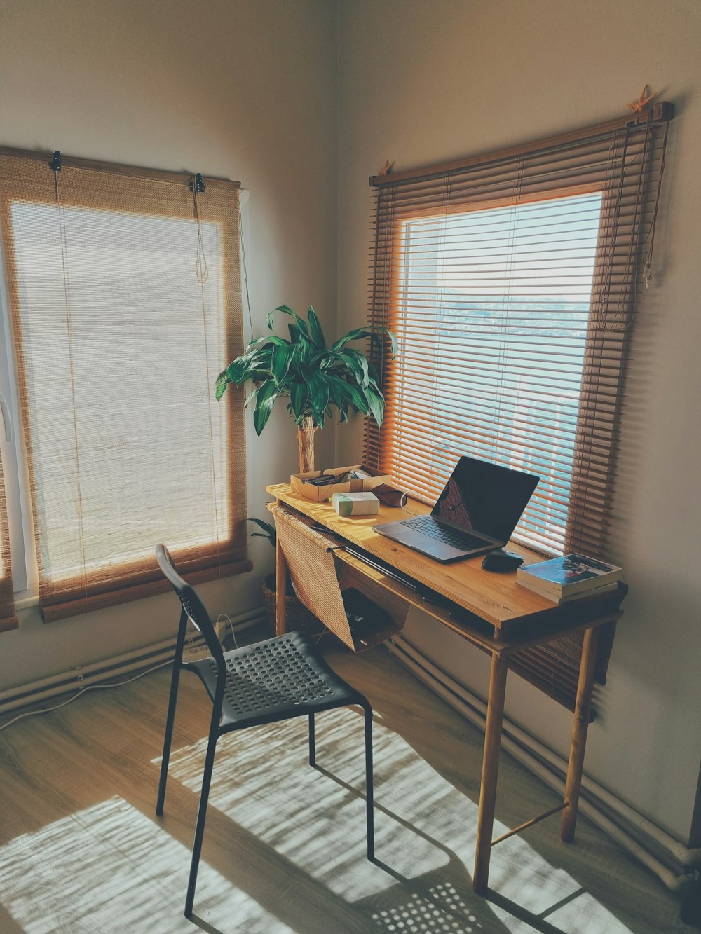 a laptop computer sitting on top of a wooden desk