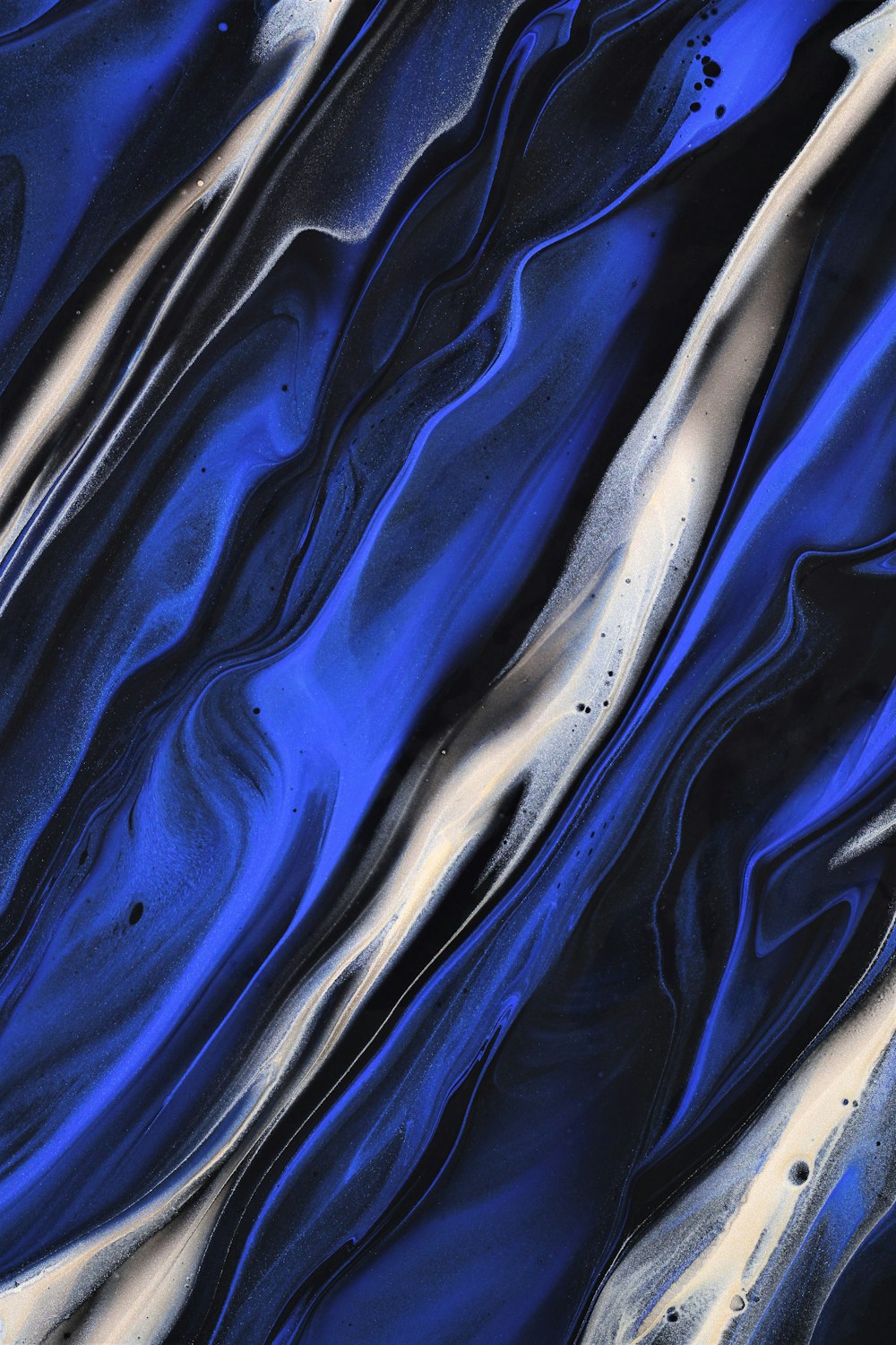 a blue and white abstract painting with a black background