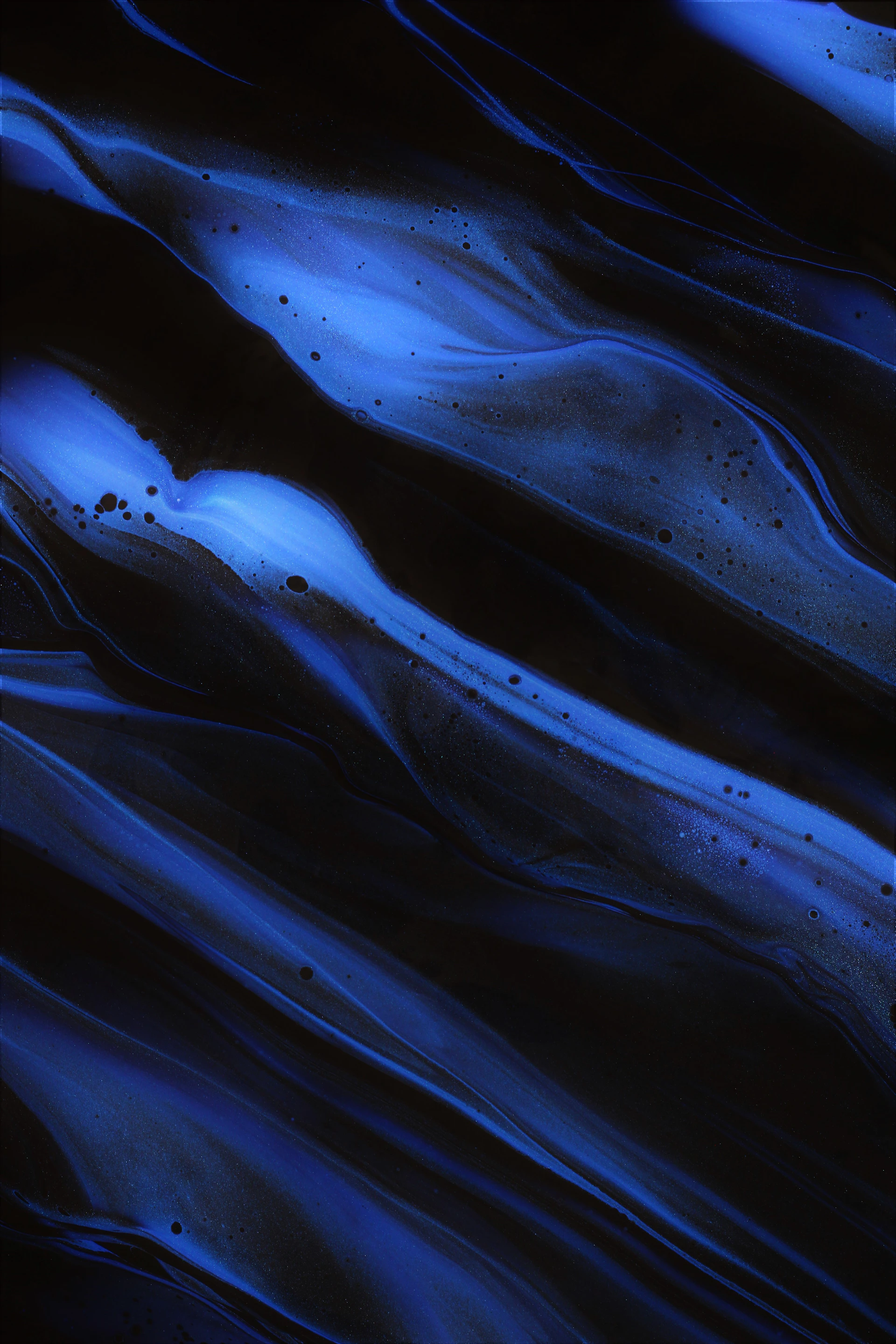 a black background with blue swirls and bubbles