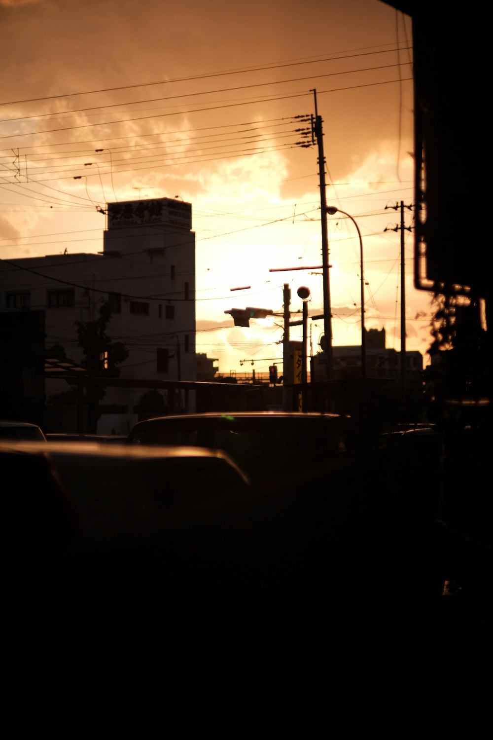 the sun is setting over a city with tall buildings