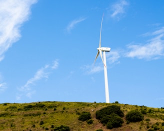 a wind turbine on top of a hill
