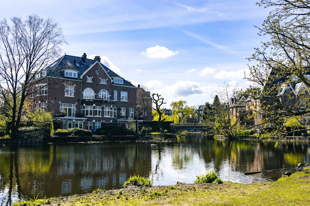 a large house sitting on the side of a river