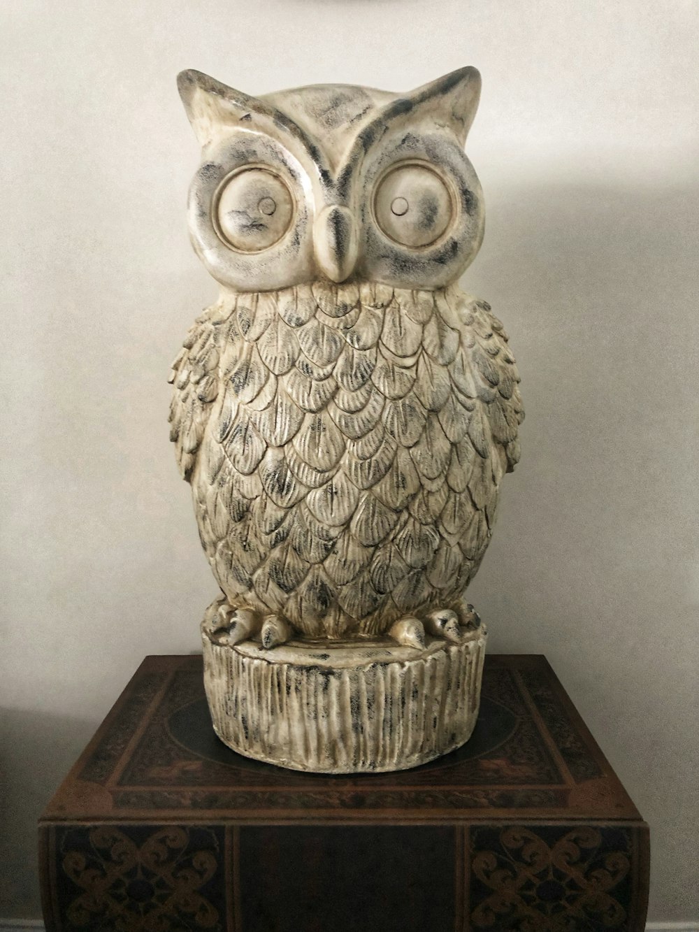 an owl statue sitting on top of a table