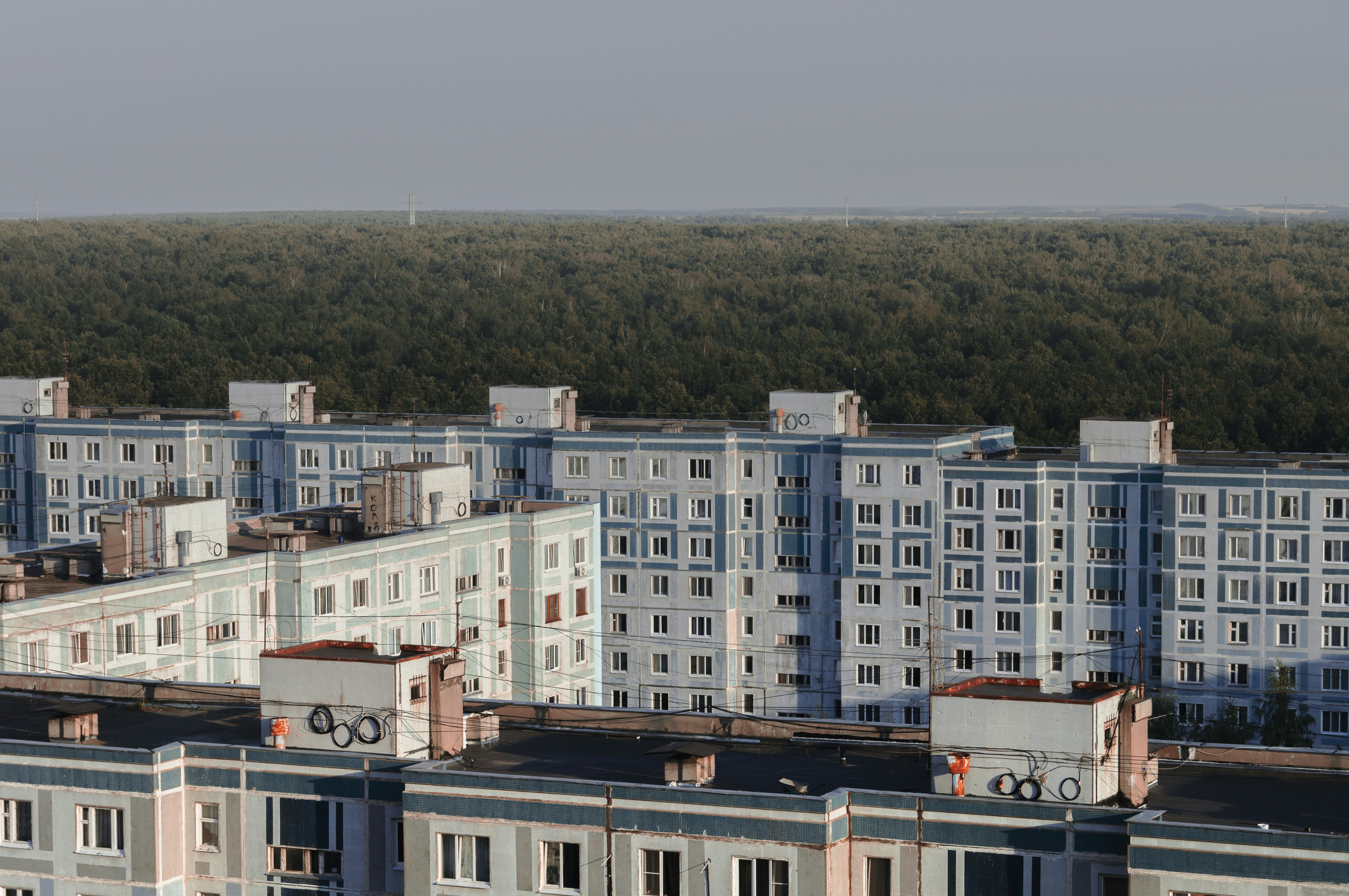 a large group of buildings with trees in the background