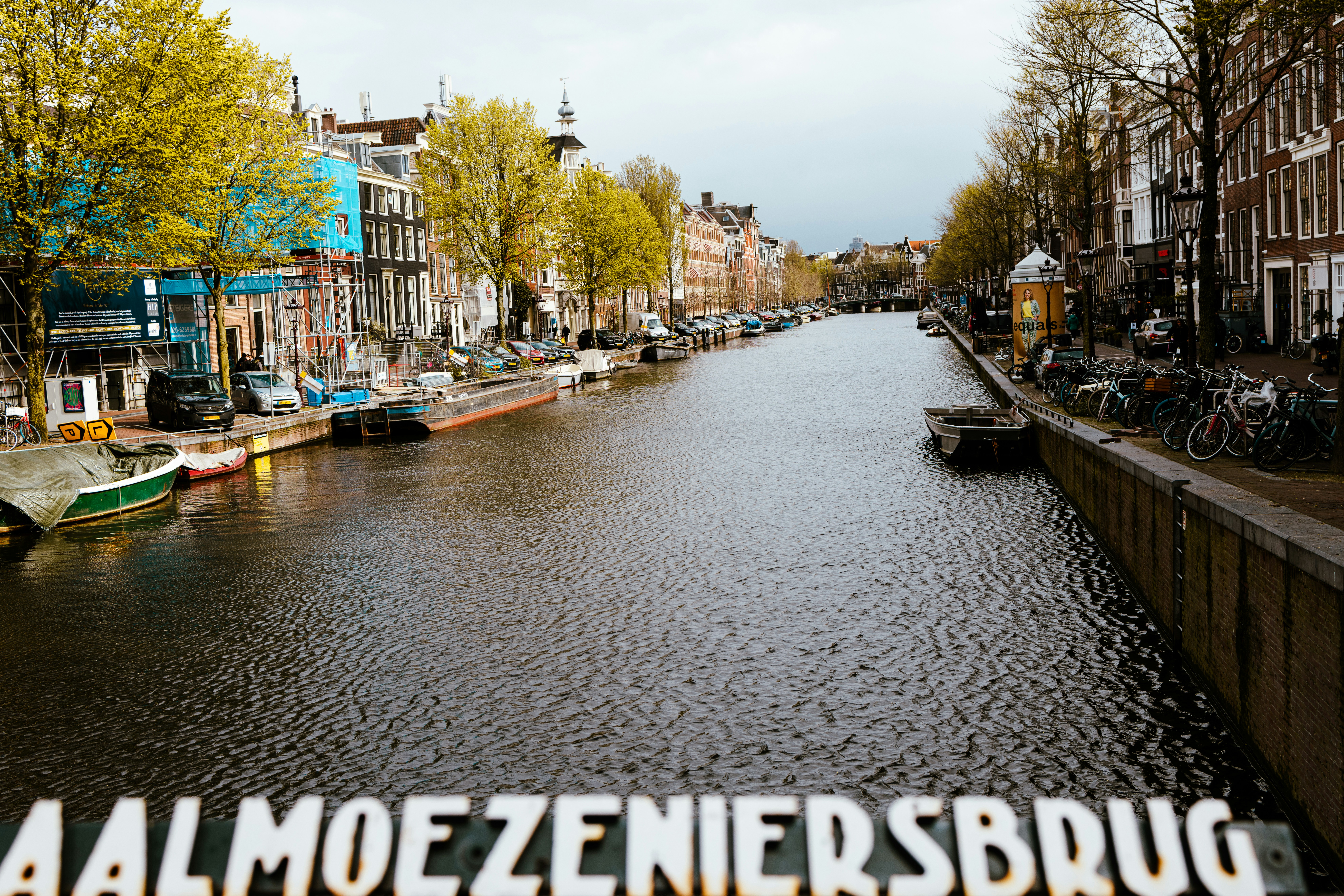 a canal with boats and bicycles on it
