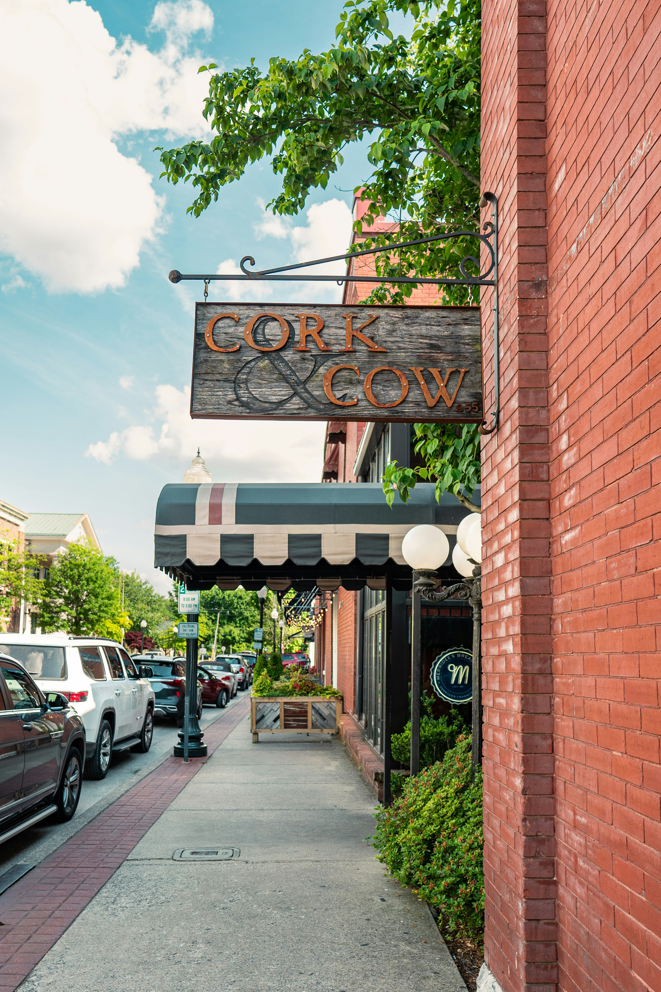 a brick building with a sign that says cork and grow