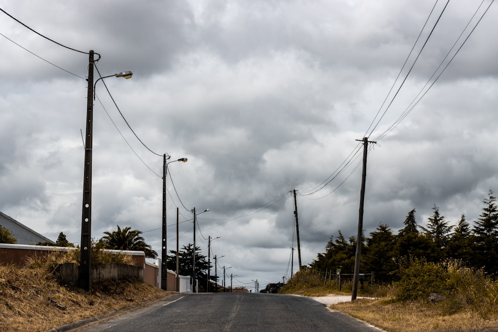 an empty street with power lines and telephone poles