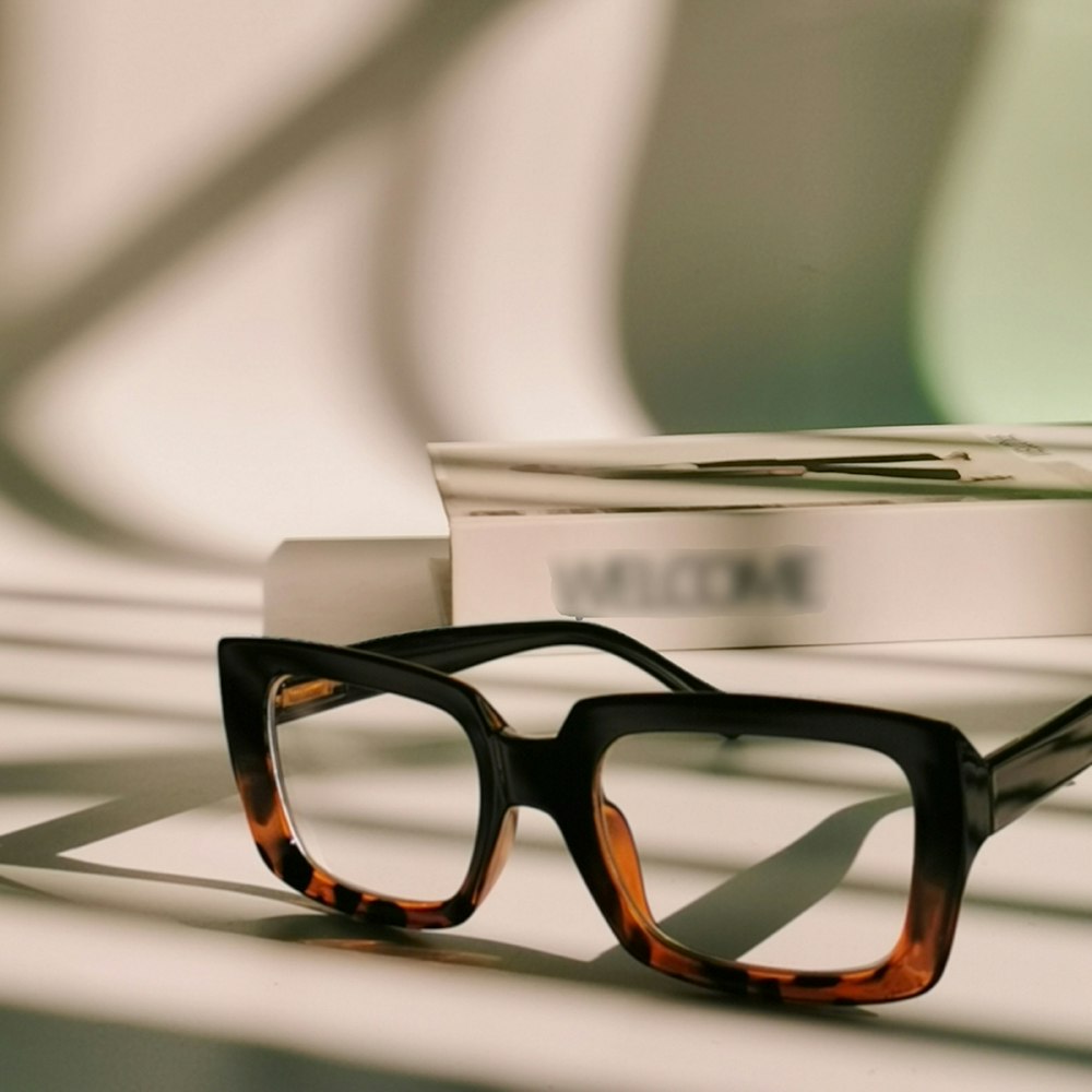 a pair of glasses sitting on top of a table