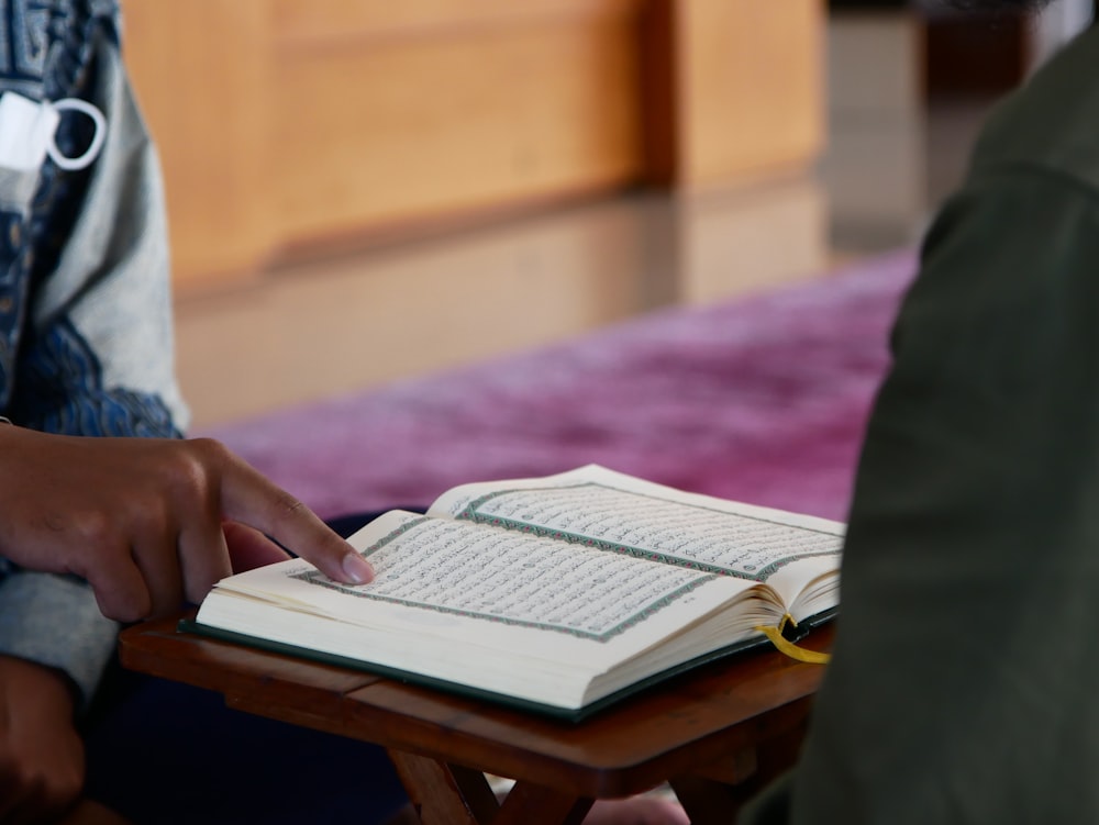 a person sitting down reading a book