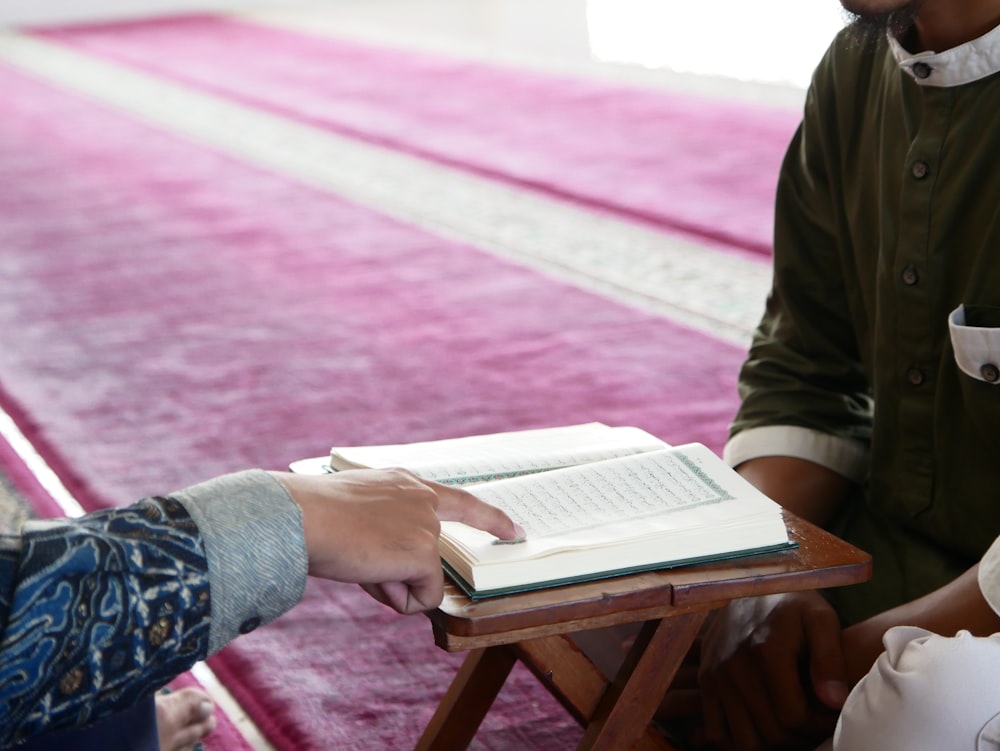 a person is holding a book in their hand