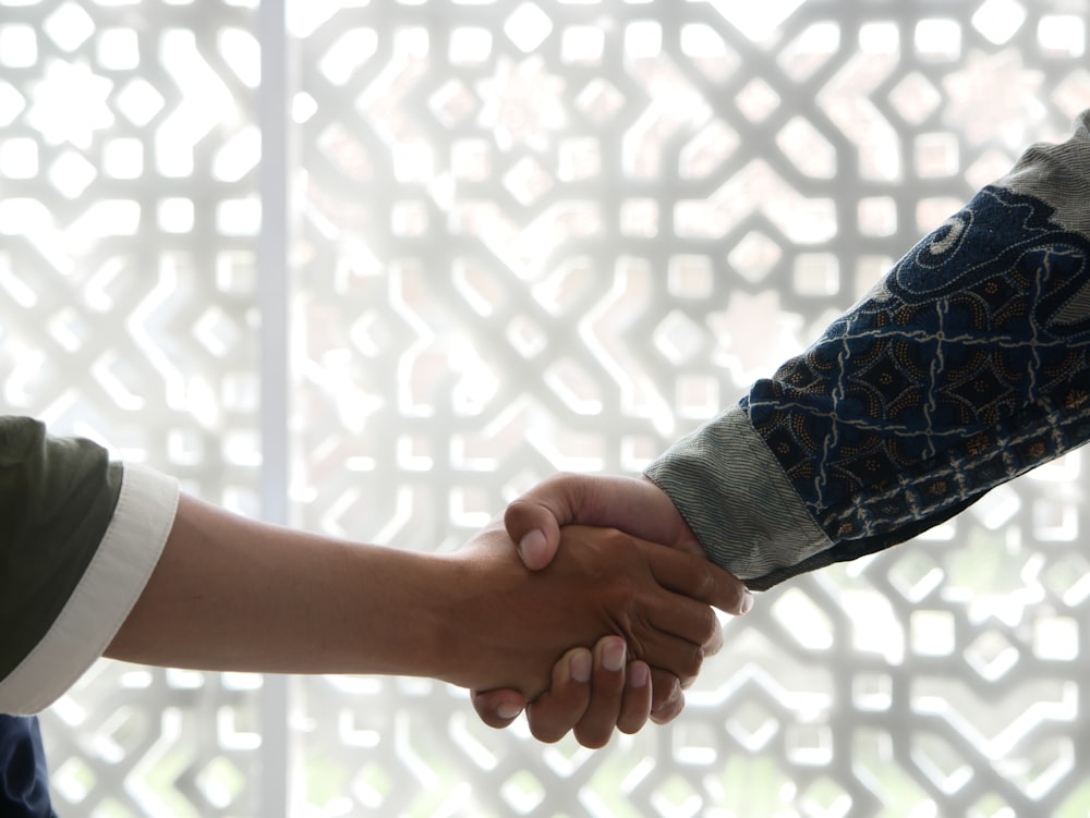a close up of two people shaking hands