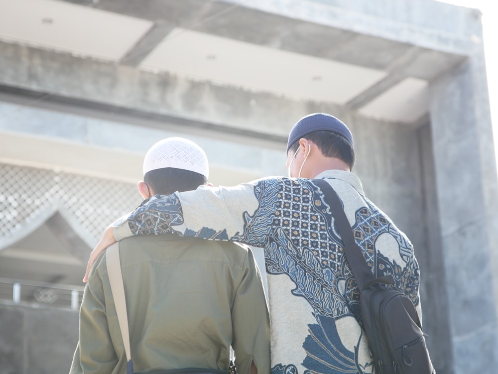 a couple of men standing next to each other