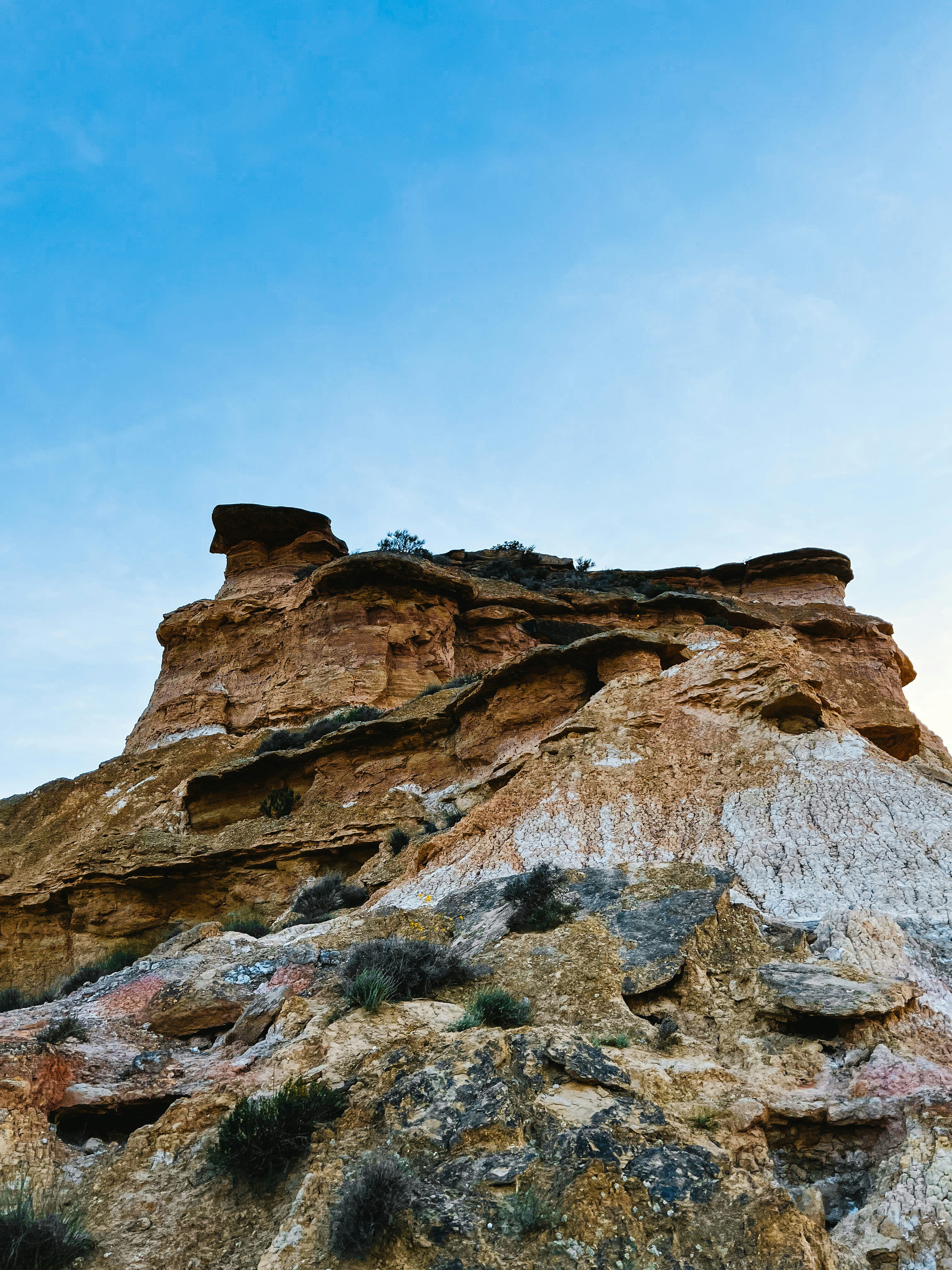 a large rock formation with a sky in the background