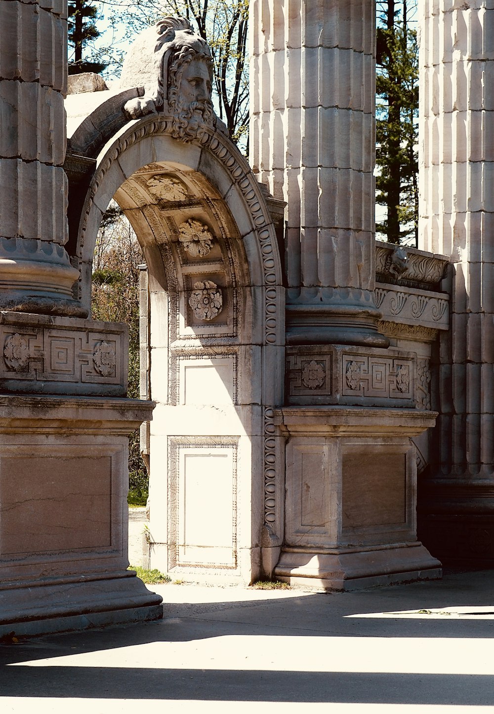 a stone arch with a clock on it