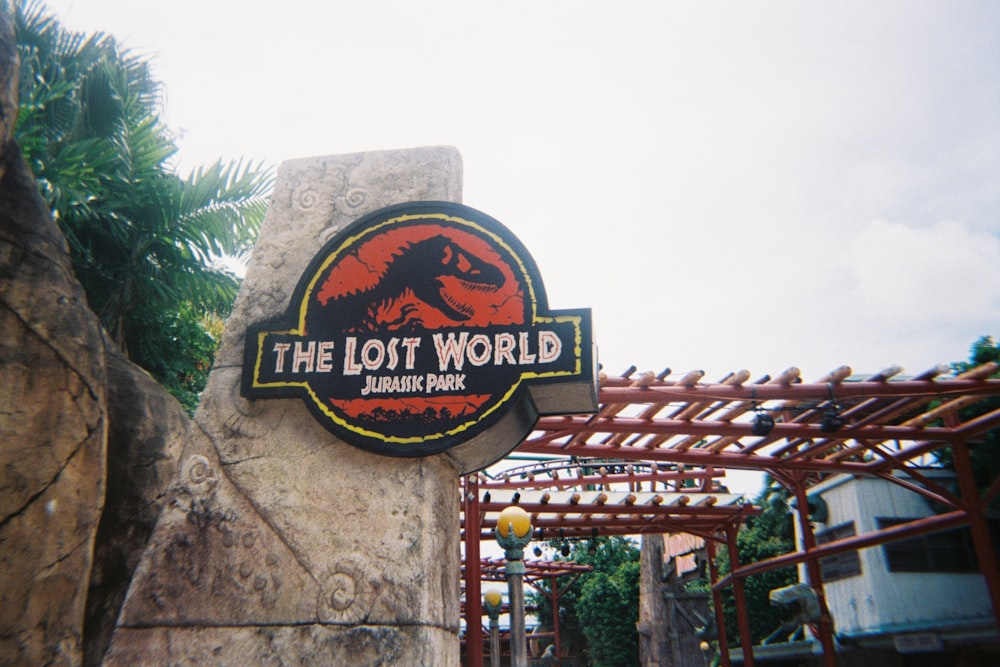 a sign for the lost world in a park