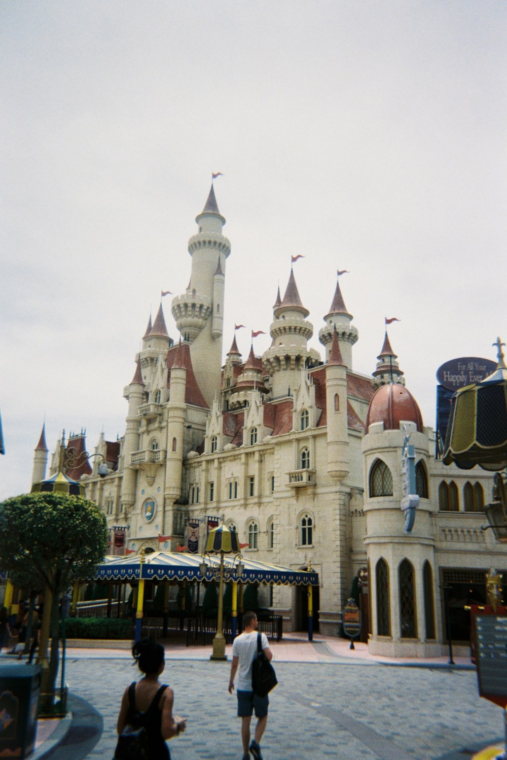 a couple of people that are standing in front of a castle