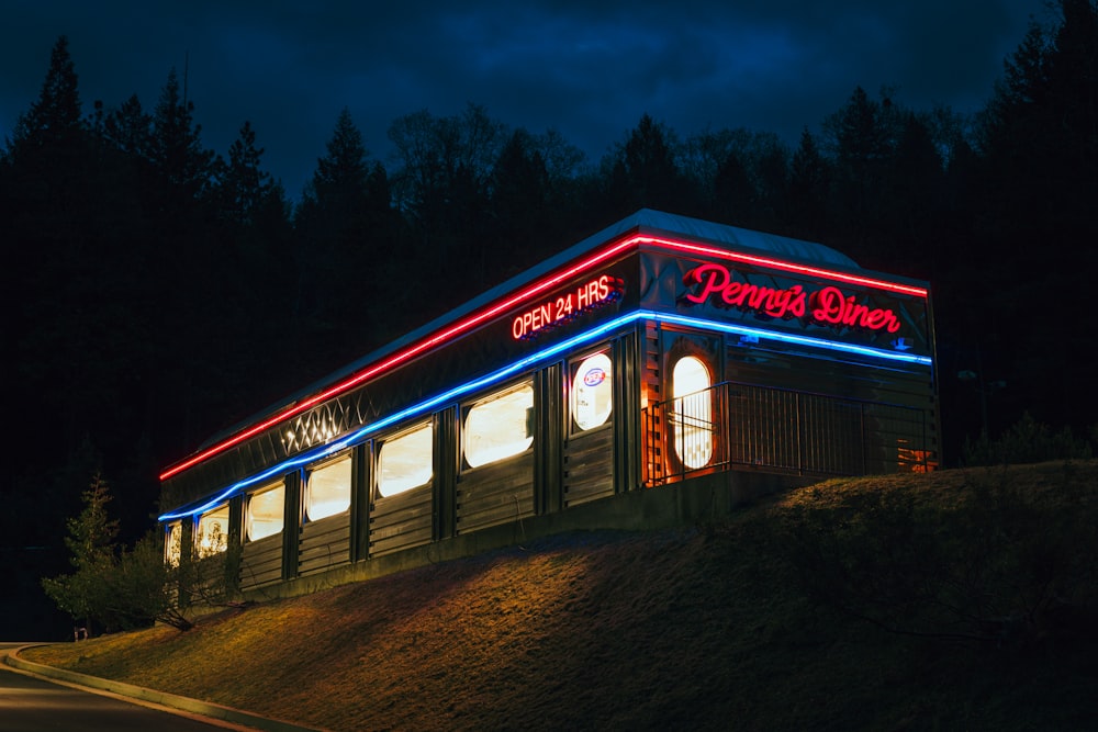 a lit up building on the side of a road